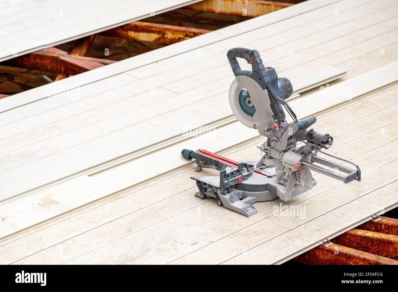 circular saws standing on the assembled composite Deck Stock Photo