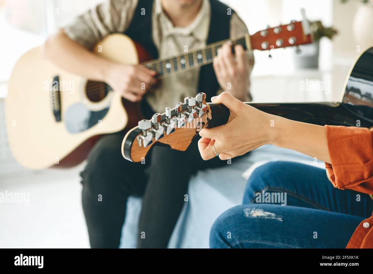 Learning to play the guitar. The teacher explains to the student the