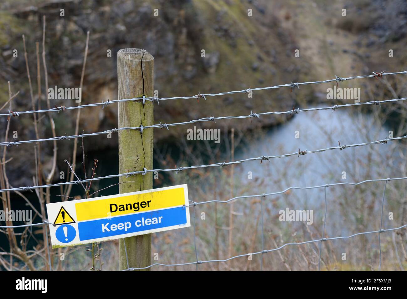 Dangerous water filled Fallgate Quarry at Ashover in Derbyshire Stock