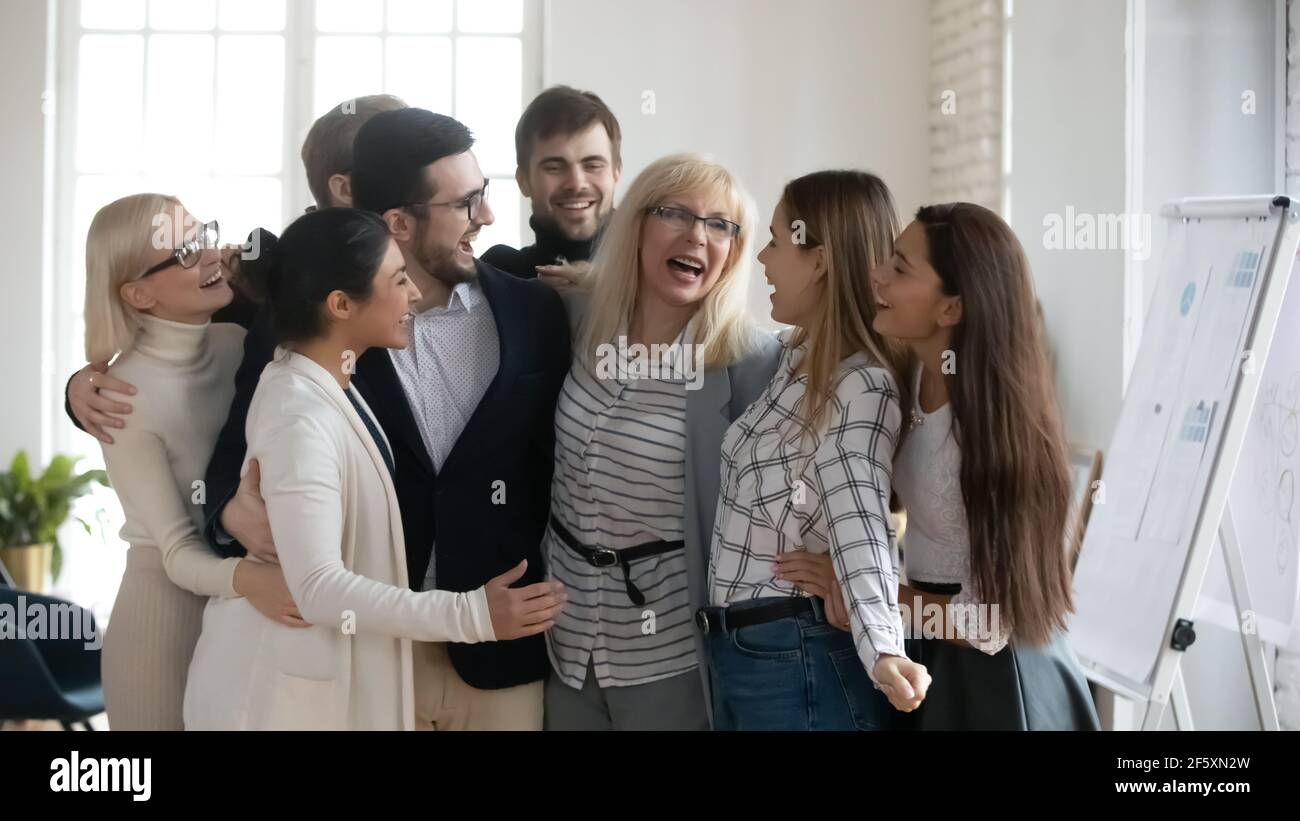 Overjoyed diverse businesspeople have fun celebrating success Stock Photo