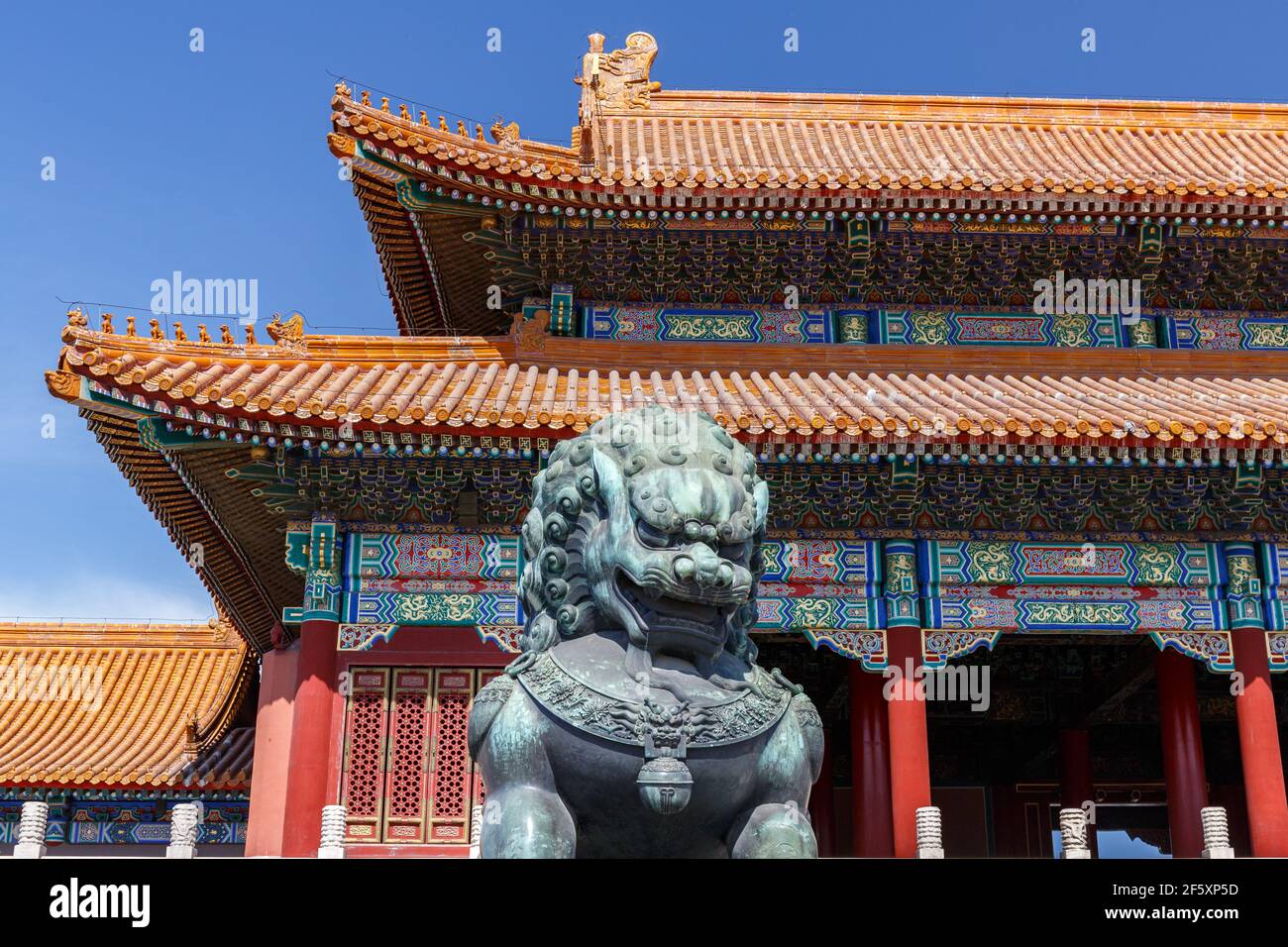 Ming-era Chinese imperial guardian lion bronze in front of a palace building at the Forbidden City in Beijing, China in March 2018. Stock Photo