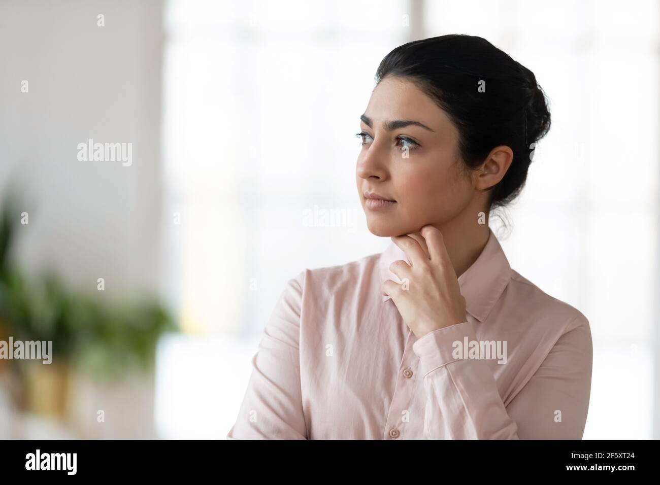 Pensive young Indian woman look in distance thinking Stock Photo - Alamy