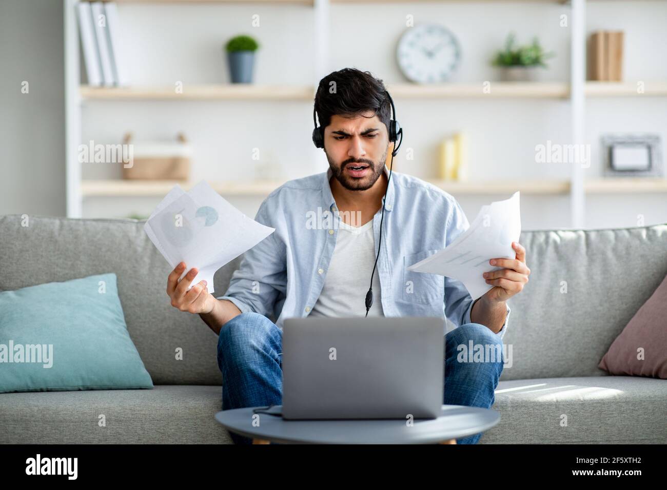 Remote business. Concerned arab man having video conference, discussing annual reports online distantly Stock Photo