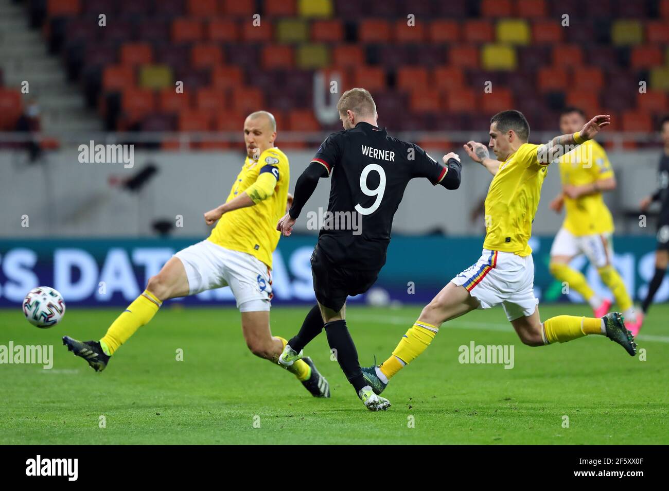 Bukarest, Romania. 28th Mar, 2021. Football: World Cup Qualification Europe, Romania - Germany, Group Stage, Group J, Matchday 2 at Arena Nationala. Germany's Timo Werner (M) and Romania's Vlad Chiriches battle for the ball. IMPORTANT NOTE: In accordance with the regulations of the DFL Deutsche Fußball Liga and the DFB Deutscher Fußball-Bund, it is prohibited to use or have used photographs taken in the stadium and/or of the match in the form of sequence pictures and/or video-like photo series. Credit: Stefan Constantin/dpa/Alamy Live News Stock Photo