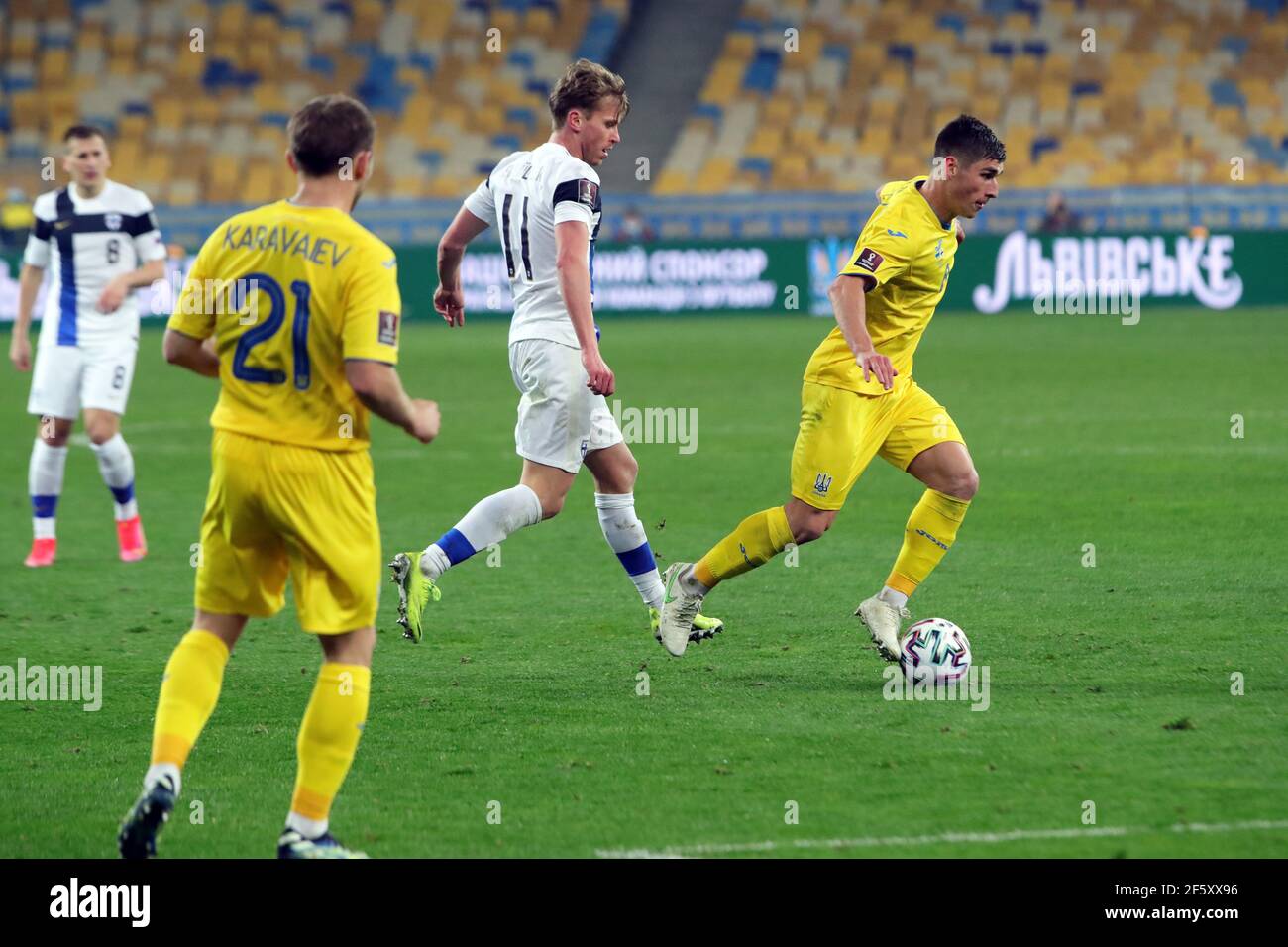 Kyiv, Ukraine . 28th Mar, 2021. KYIV, UKRAINE - MARCH 28, 2021 - Midfielder Rasmus Schuller (C) of Finland is seen in action with defender Oleksandr Karavaev (L) and midfielder Ruslan Malinovskyi (R) of Ukraine during the FIFA World Cup 2022 Qualifying Round Matchday 2 Group D game at the NSC Olimpiyskiy, Kyiv, capital of Ukraine. Credit: Ukrinform/Alamy Live News Stock Photo