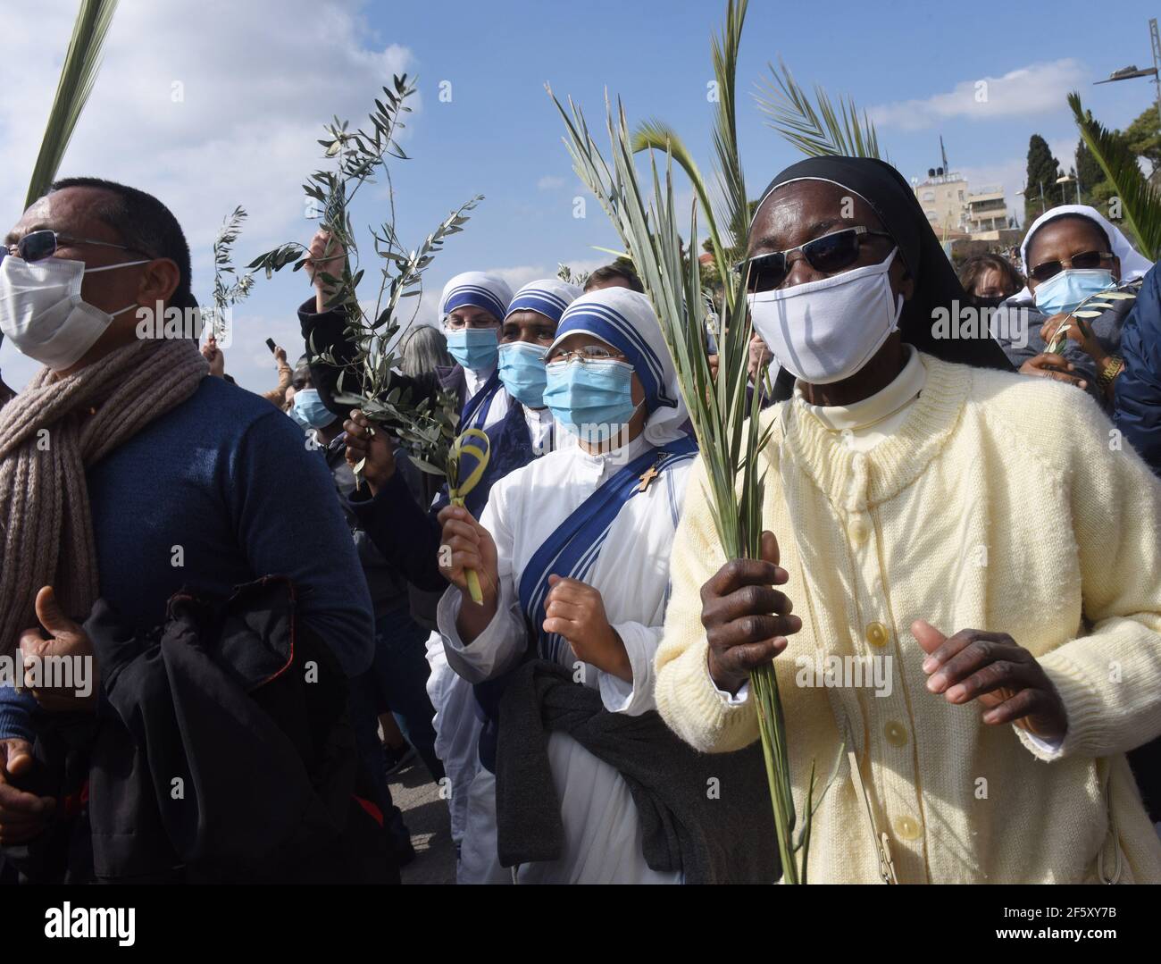 Jerusalem, Israel. 28th Mar, 2021. Christians carry palm and olive branches in the traditional Palm Sunday Procession on the Mt. of Olives, on Sunday, March 28, 2021. Palm Sunday commemorates the triumphant entry of Jesus into Jerusalem and it starts the Holy Week. Photo by Debbie Hill/UPI Credit: UPI/Alamy Live News Stock Photo