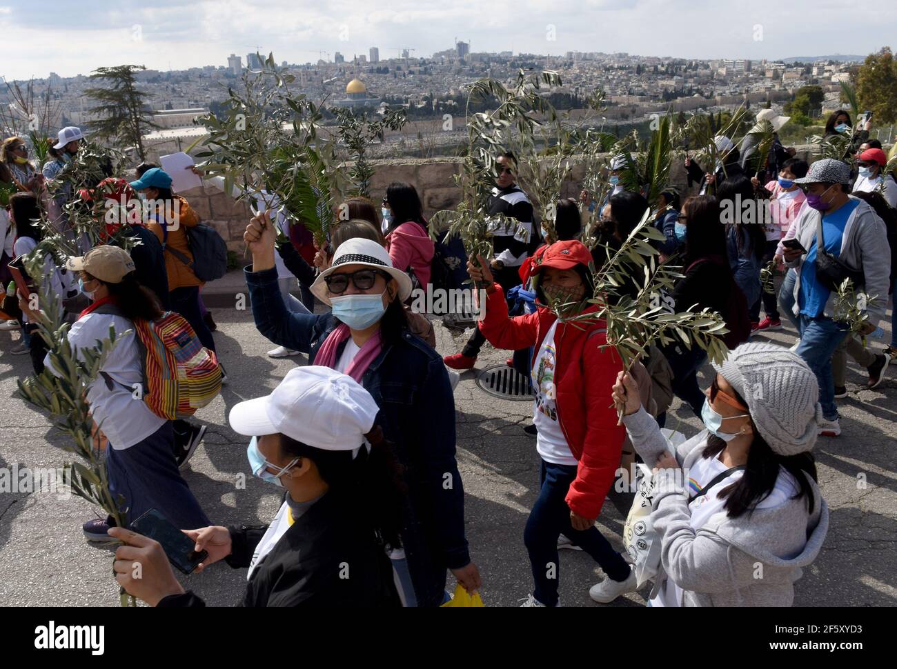 Jerusalem, Israel. 28th Mar, 2021. Christians carry palm and olive branches in the traditional Palm Sunday Procession on the Mt. of Olives, on Sunday, March 28, 2021. Palm Sunday commemorates the triumphant entry of Jesus into Jerusalem and it starts the Holy Week. Photo by Debbie Hill/UPI Credit: UPI/Alamy Live News Stock Photo
