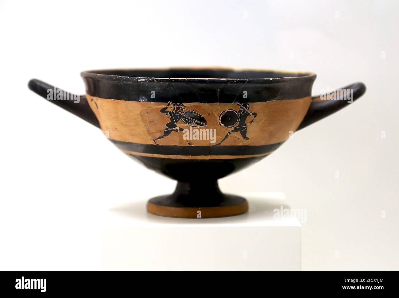 Cup with combat scene. Black figure pottery, Attic worK, 4th cent. BC. Empuries, Archaeology Museum of Catalonia. Barcelona, Spain. Stock Photo