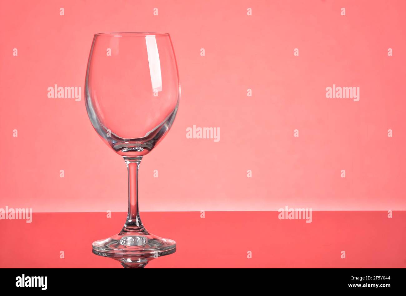 Empty wine glass laying with focus on the stem of the glass. Selective focus points. Blurred background Stock Photo