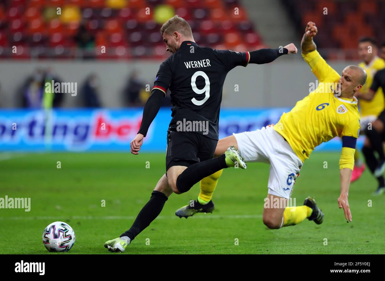 Bukarest, Romania. 28th Mar, 2021. Football: World Cup Qualification Europe, Romania - Germany, Group Stage, Group J, Matchday 2 at Arena Nationala. Germany's Timo Werner (l) and Romania's Vlad Chiriches battle for the ball. IMPORTANT NOTE: In accordance with the regulations of the DFL Deutsche Fußball Liga and the DFB Deutscher Fußball-Bund, it is prohibited to use or have used photographs taken in the stadium and/or of the match in the form of sequence pictures and/or video-like photo series. Credit: Stefan Constantin/dpa/Alamy Live News Stock Photo