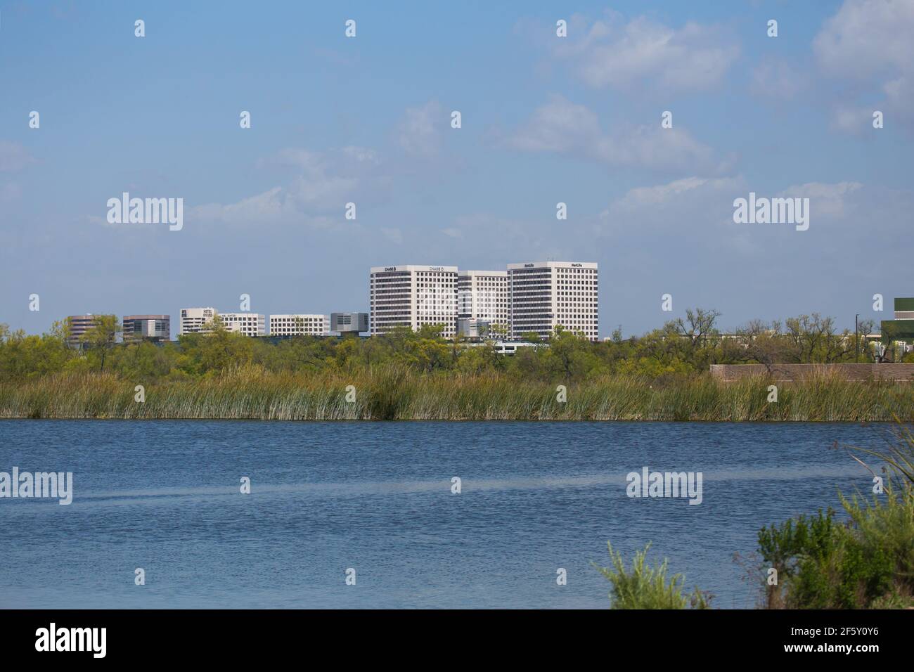 office buildings in the city of Irvine, Orange County, California. viewed across a pond from the