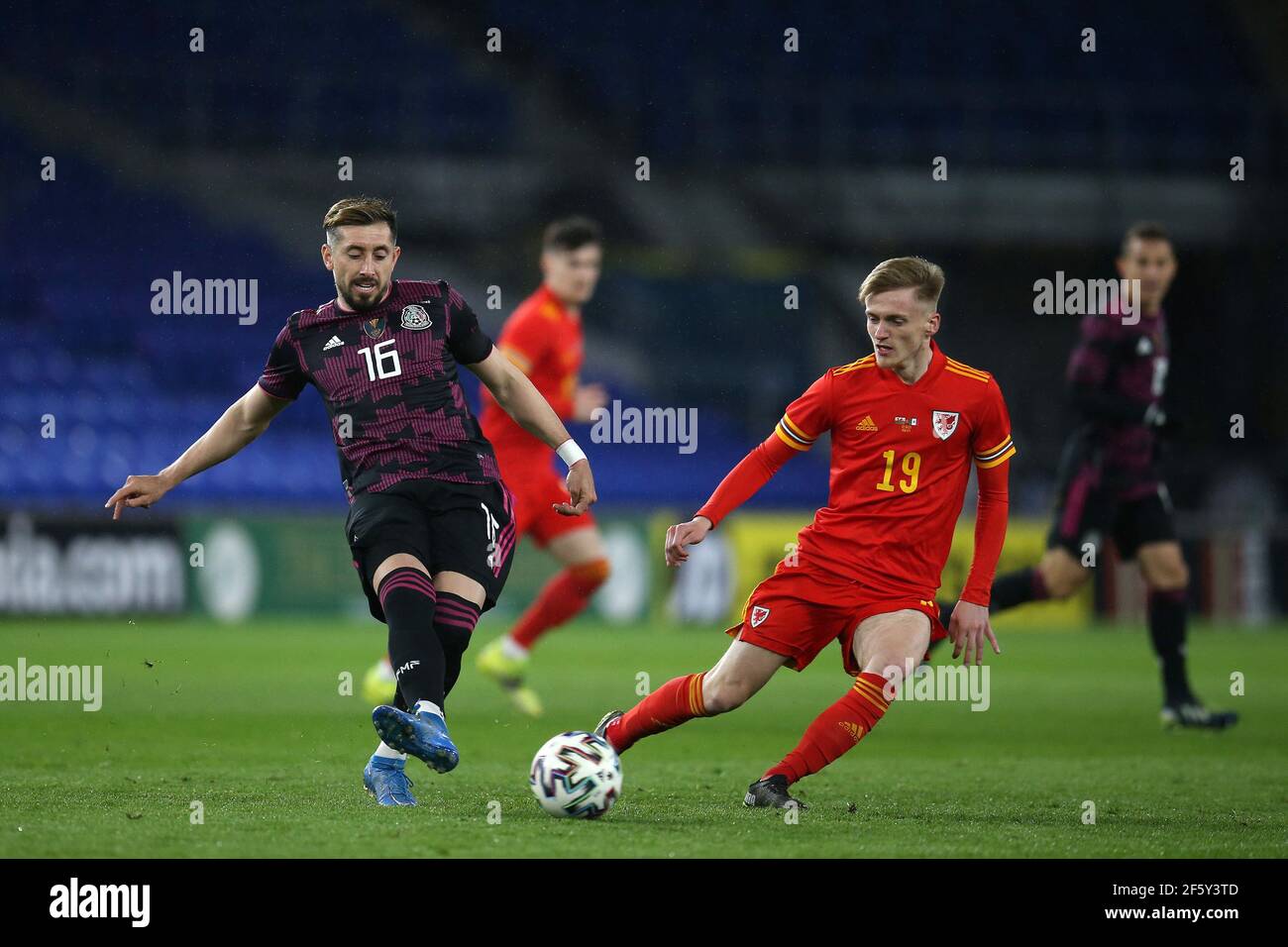 Cardiff, UK. 27th Mar, 2021. Hector Herrera of Mexico (l) and Matthew Smith of Wales in action. Football international friendly match, Wales v Mexico, at the Cardiff city stadium in Cardiff, South Wales on Saturday 27th March 2021. Editorial use only. pic by Andrew Orchard/Andrew Orchard sports photography/Alamy Live News Credit: Andrew Orchard sports photography/Alamy Live News Stock Photo