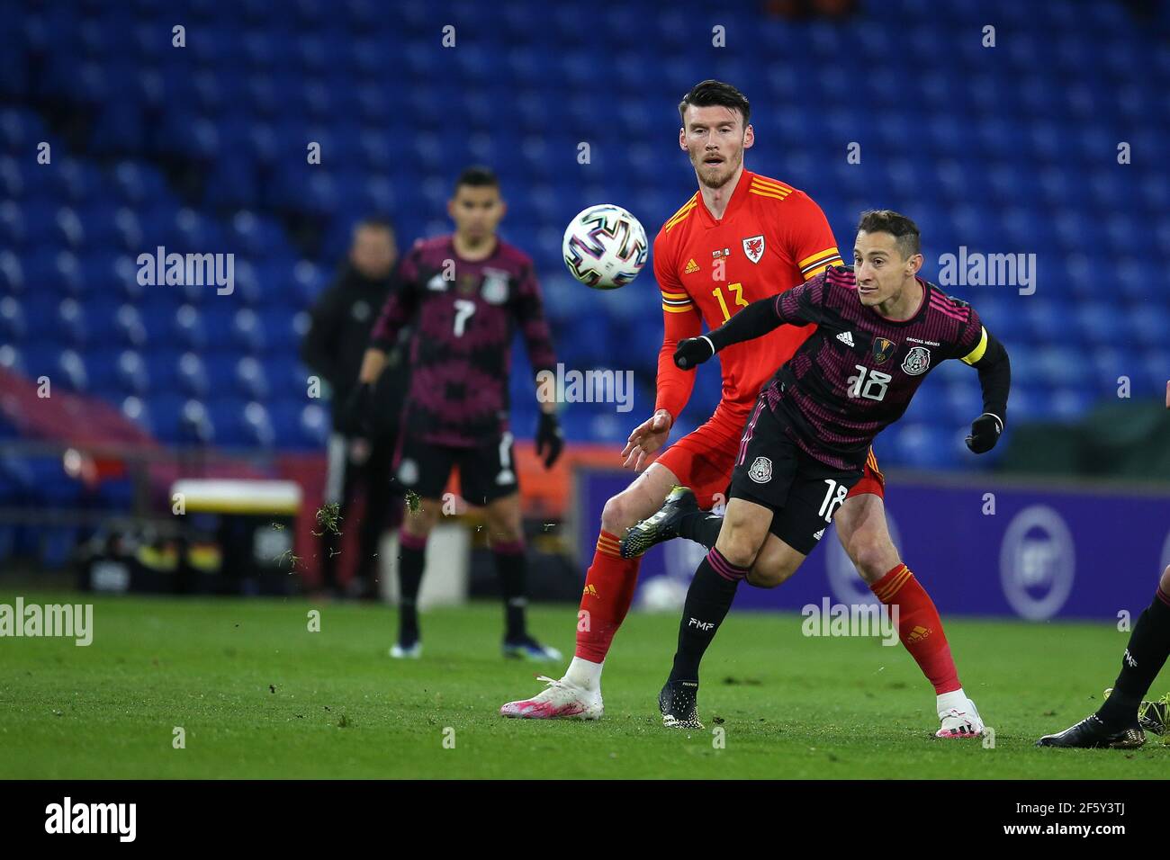 Cardiff, UK. 27th Mar, 2021. Andres Guardado of Mexico (r) and Kieffer Moore of Wales (c) in action. Football international friendly match, Wales v Mexico, at the Cardiff city stadium in Cardiff, South Wales on Saturday 27th March 2021. Editorial use only. pic by Andrew Orchard/Andrew Orchard sports photography/Alamy Live News Credit: Andrew Orchard sports photography/Alamy Live News Stock Photo