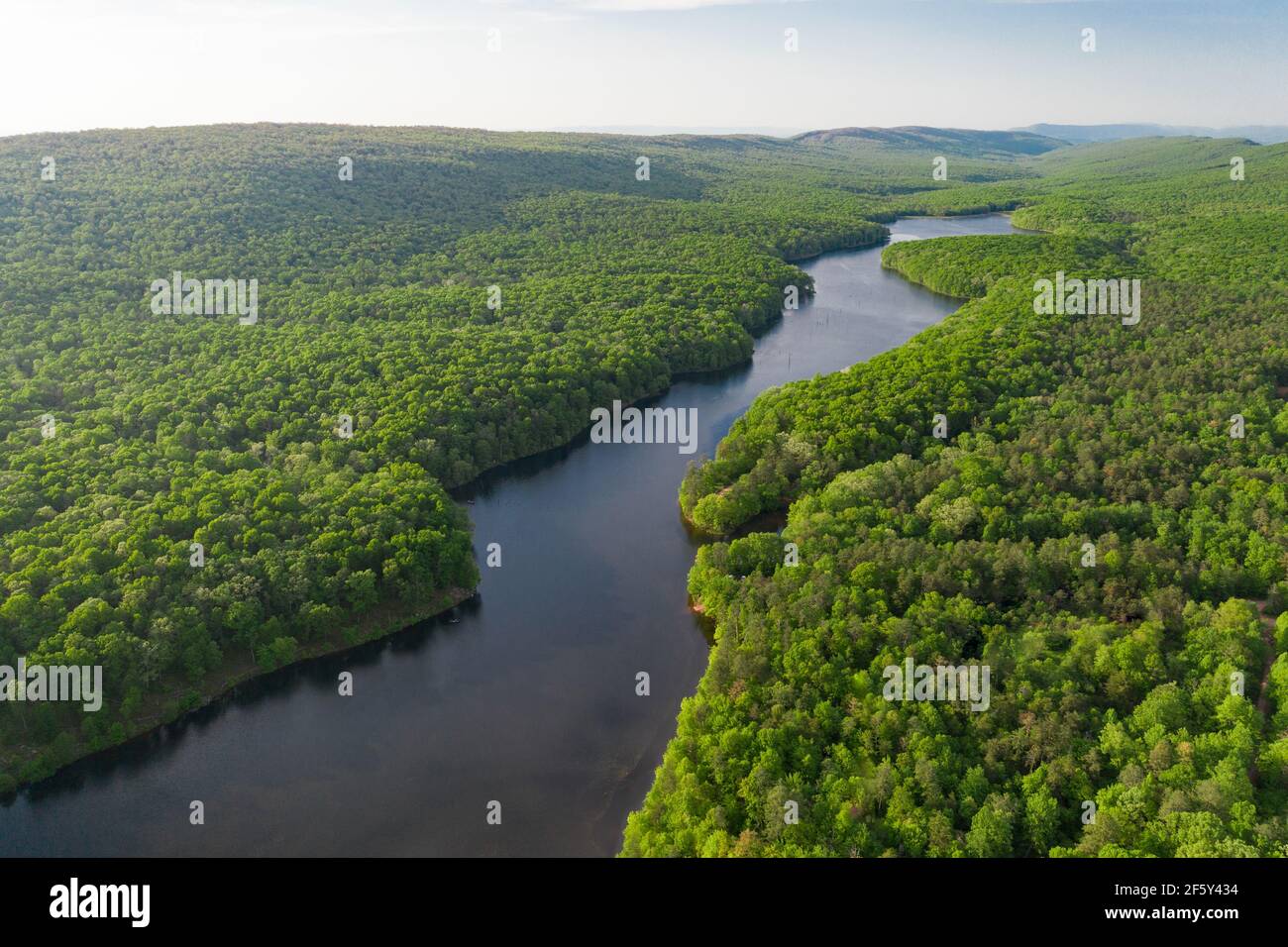 Aerials Over Big Lake in Forest Covered Hills Stock Photo