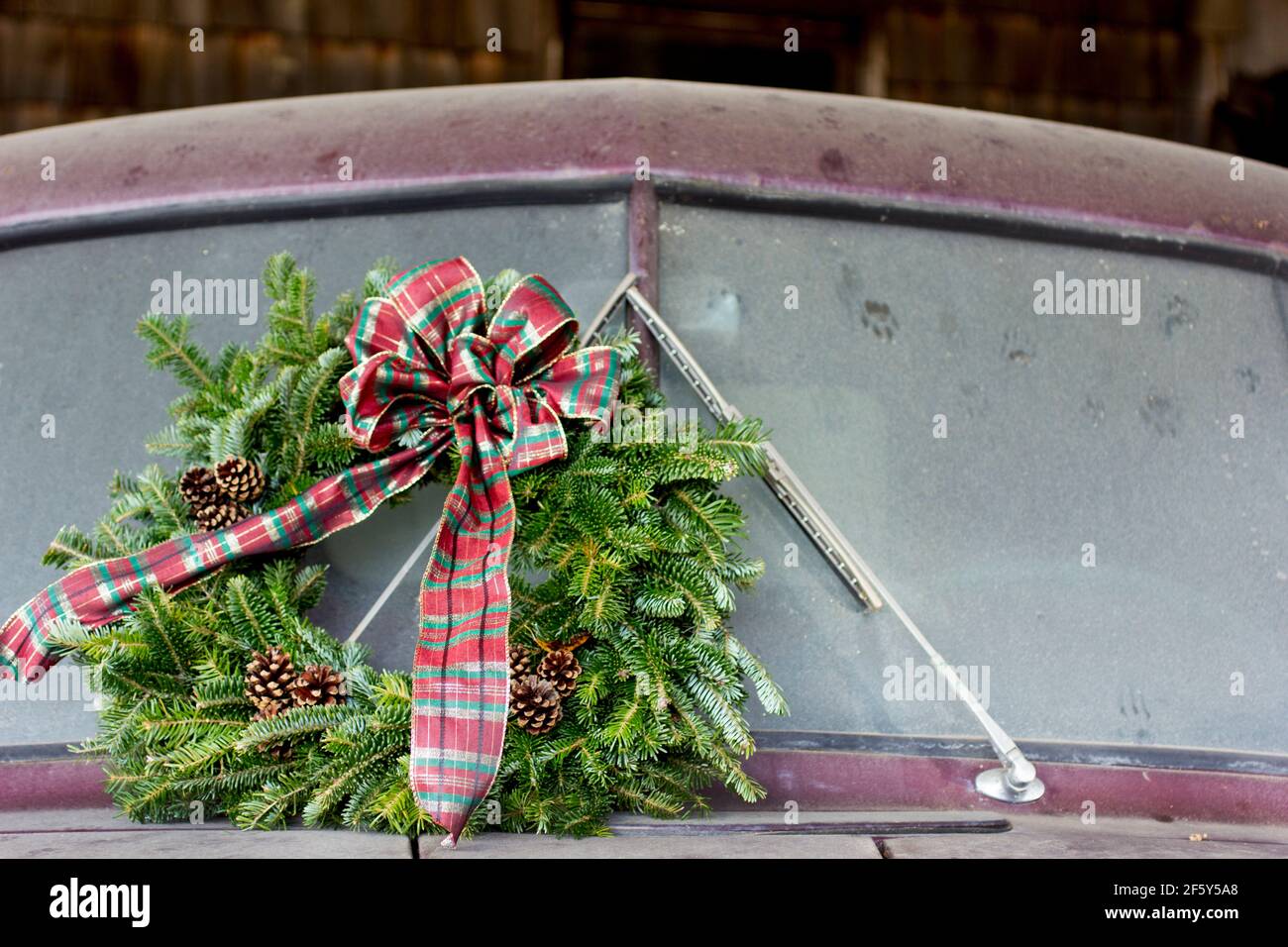 An old Dodge Truck is parked and ready for the holidays with a Winter Christmas Wreath on the front Stock Photo