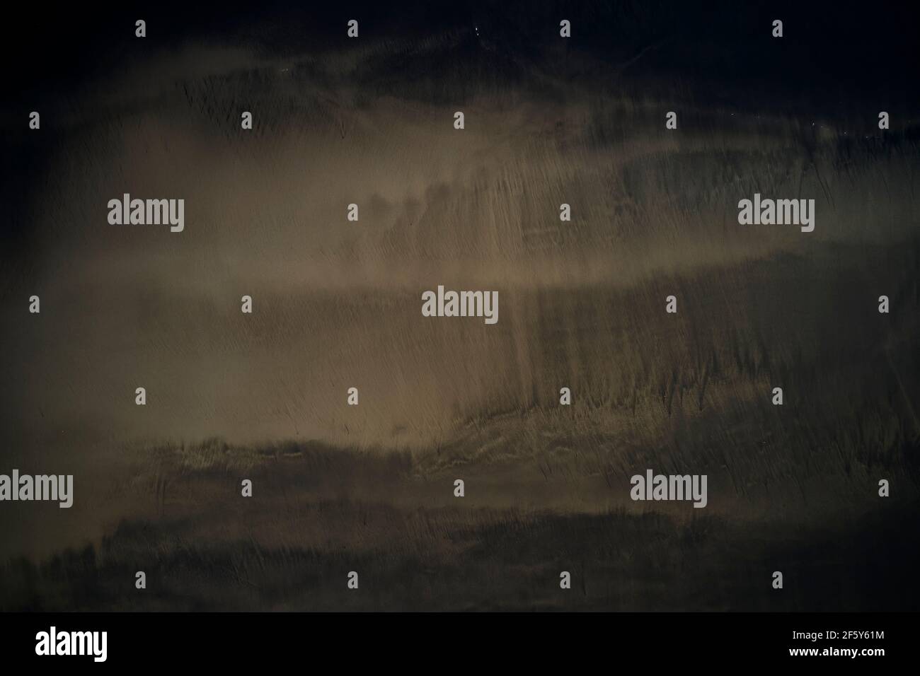 Rippled wet dark sand on coast Stock Photo