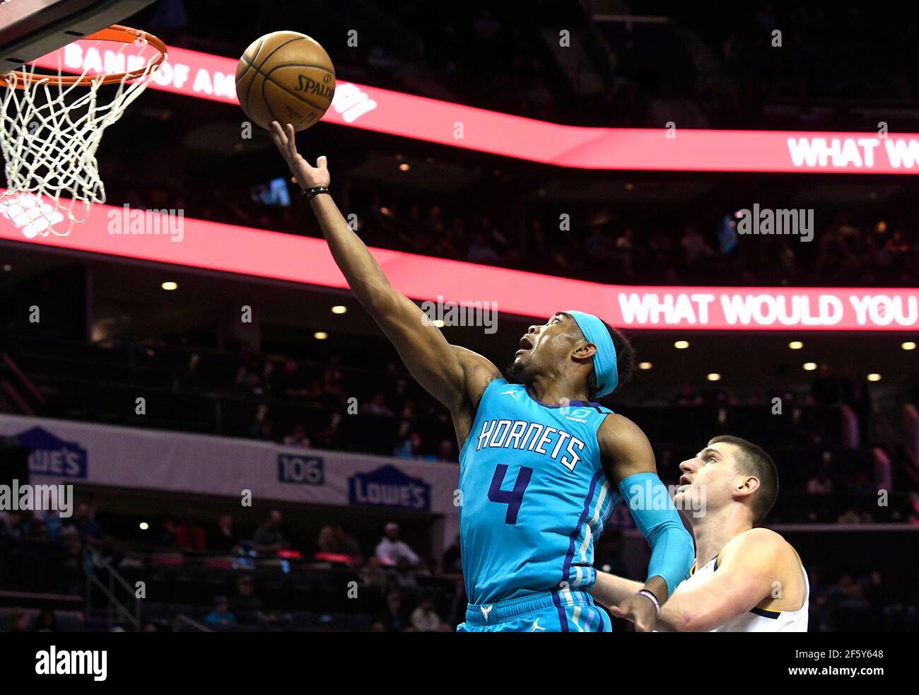 Charlotte, USA. 05th Mar, 2020. In this photo from March 5, 2020, the Charlotte Hornets' Devonte' Graham (4) drives past the Denver Nuggets' Nikola Jokic in the first half at the Spectrum Center in Charlotte, North Carolina. (Photo by David T. Foster III/Charlotte Observer/TNS/Sipa USA) Credit: Sipa USA/Alamy Live News Stock Photo