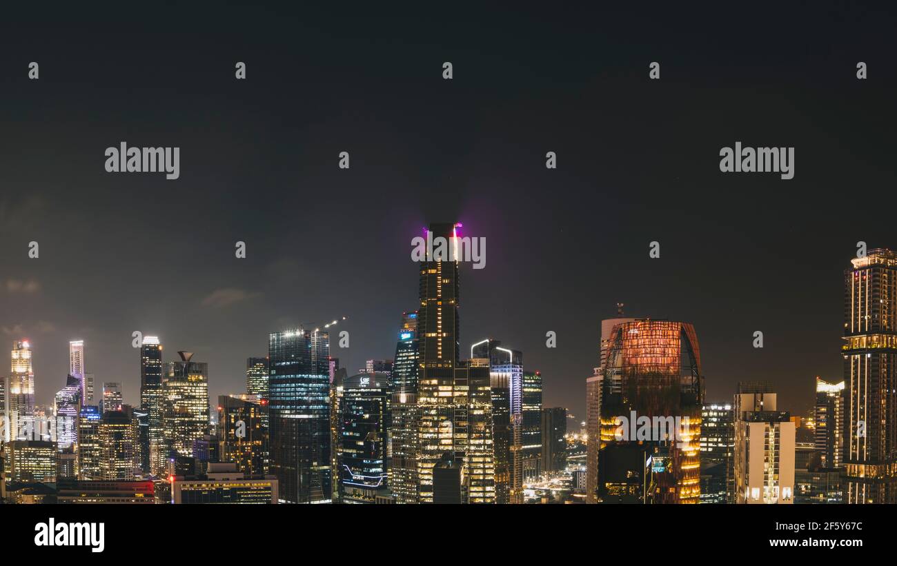 Panorama cityscape of Singapore city skyline at night from a rooftop viewpoint. Stock Photo