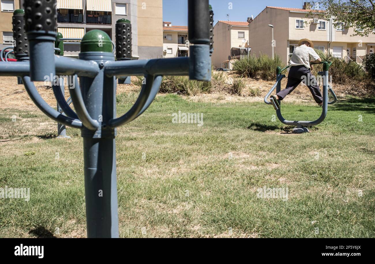 Healthy active ageing concept. Elder man make exercises at Outdoor Gym Stock Photo