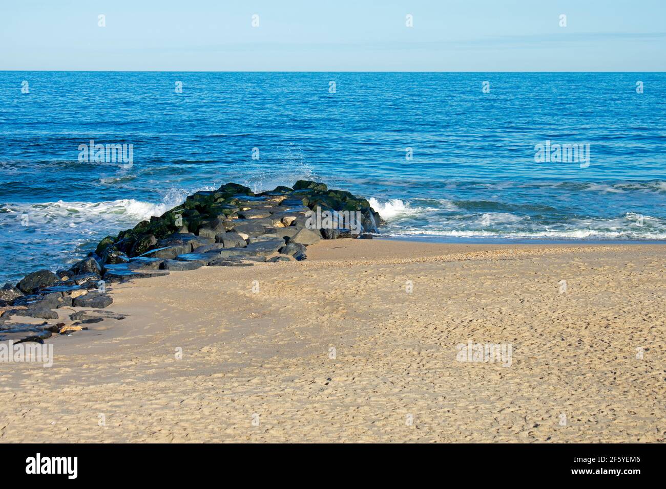 Heavy surf crashing into a sandy shoreline at Monmouth Beach, New Jersey, USA, on a sunny afternoon in early Spring  -05 Stock Photo