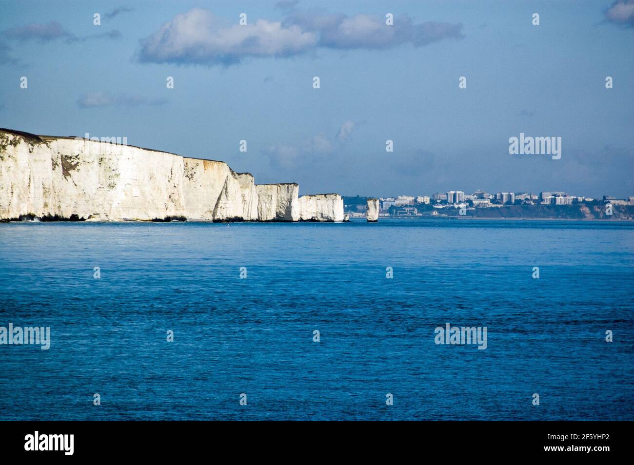 The geographical feature known as Old Harry Rocks viewed from the other side of Swanage Bay in Dorset on a sunny spring day. Stock Photo