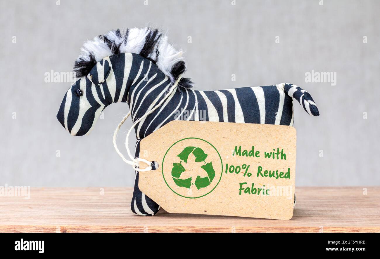 Zebra toy with Made with 100 percent reused fabric label and recycle textiles icon symbol Stock Photo