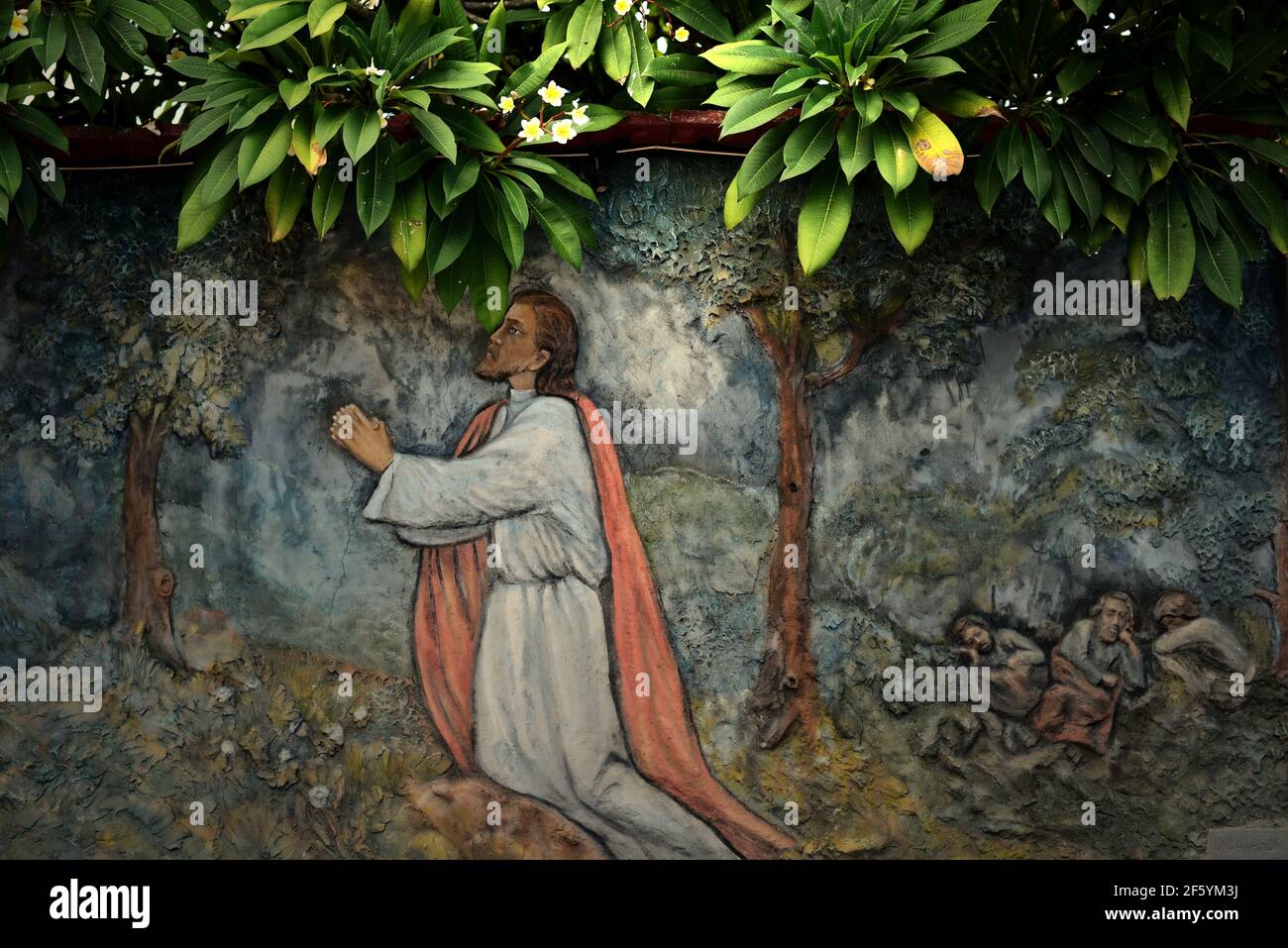 A bas-relief depicting Jesus praying at the Garden of Gethsemane, created by unidentified artist on a wall near the St Ignatius Loyola church, Sikka. Stock Photo