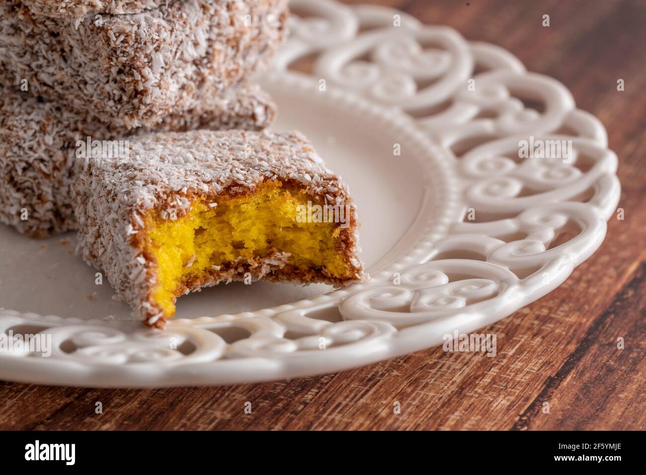 Stack of cakes with coconuts and trace of teeth. Australian cake. Stock Photo