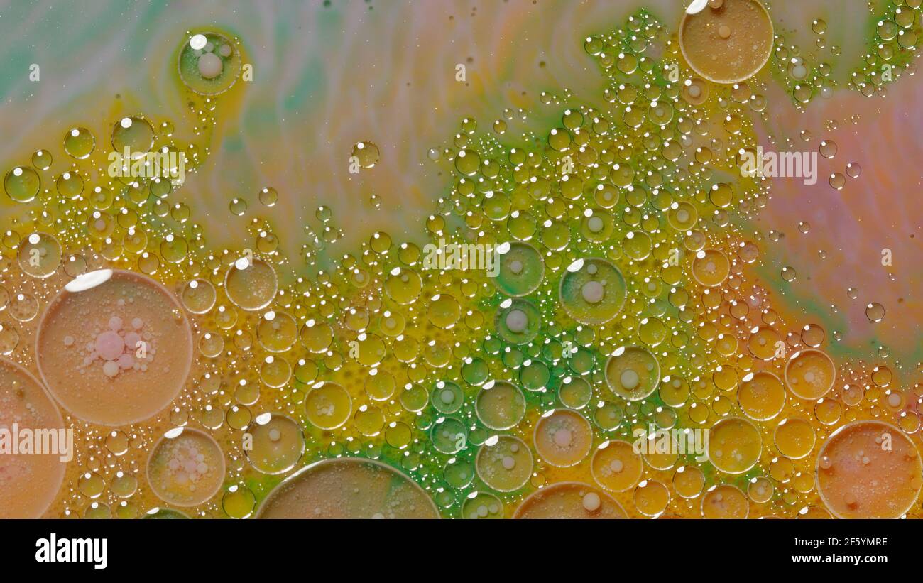 Bubbles float in liquid paint, mixing ink, oil and milk, abstract