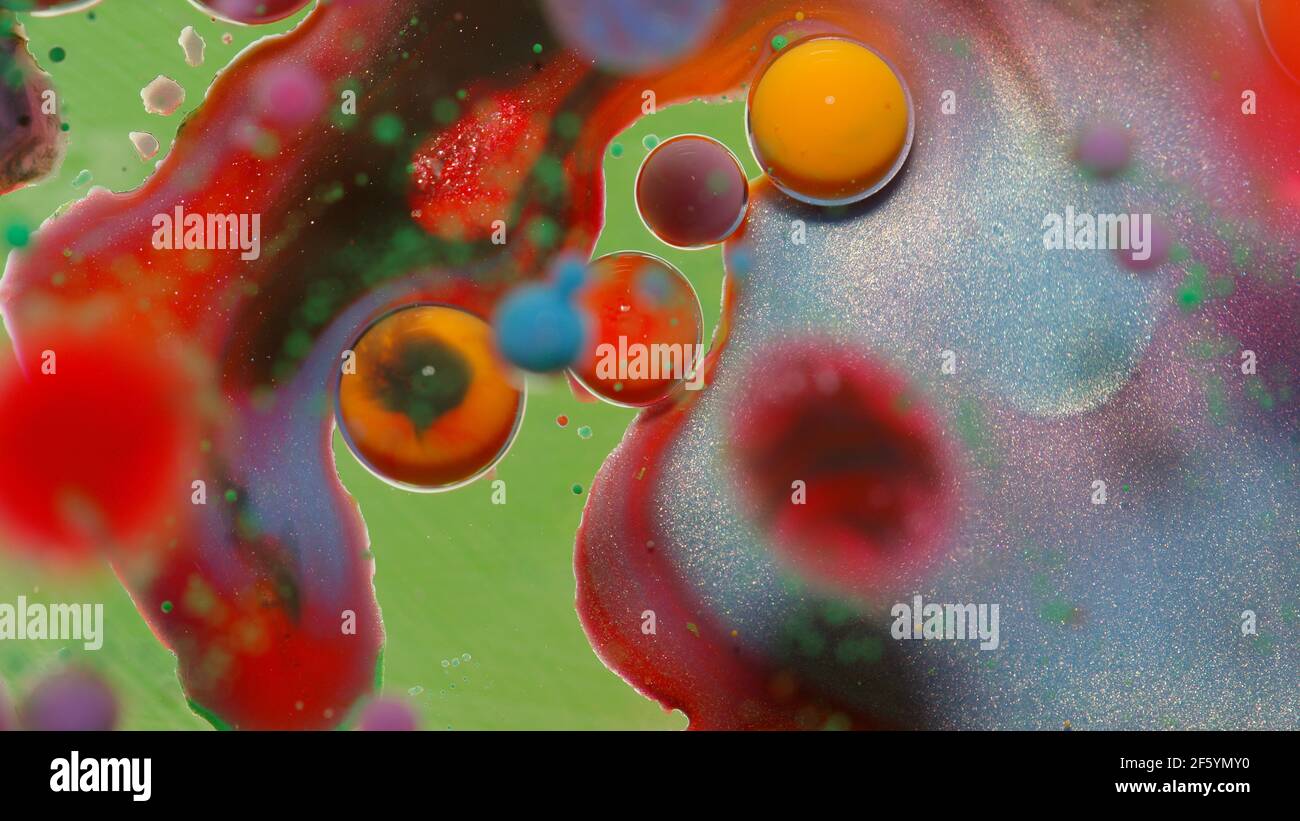 Bubbles float in liquid paint, mixing ink, oil and milk, abstract