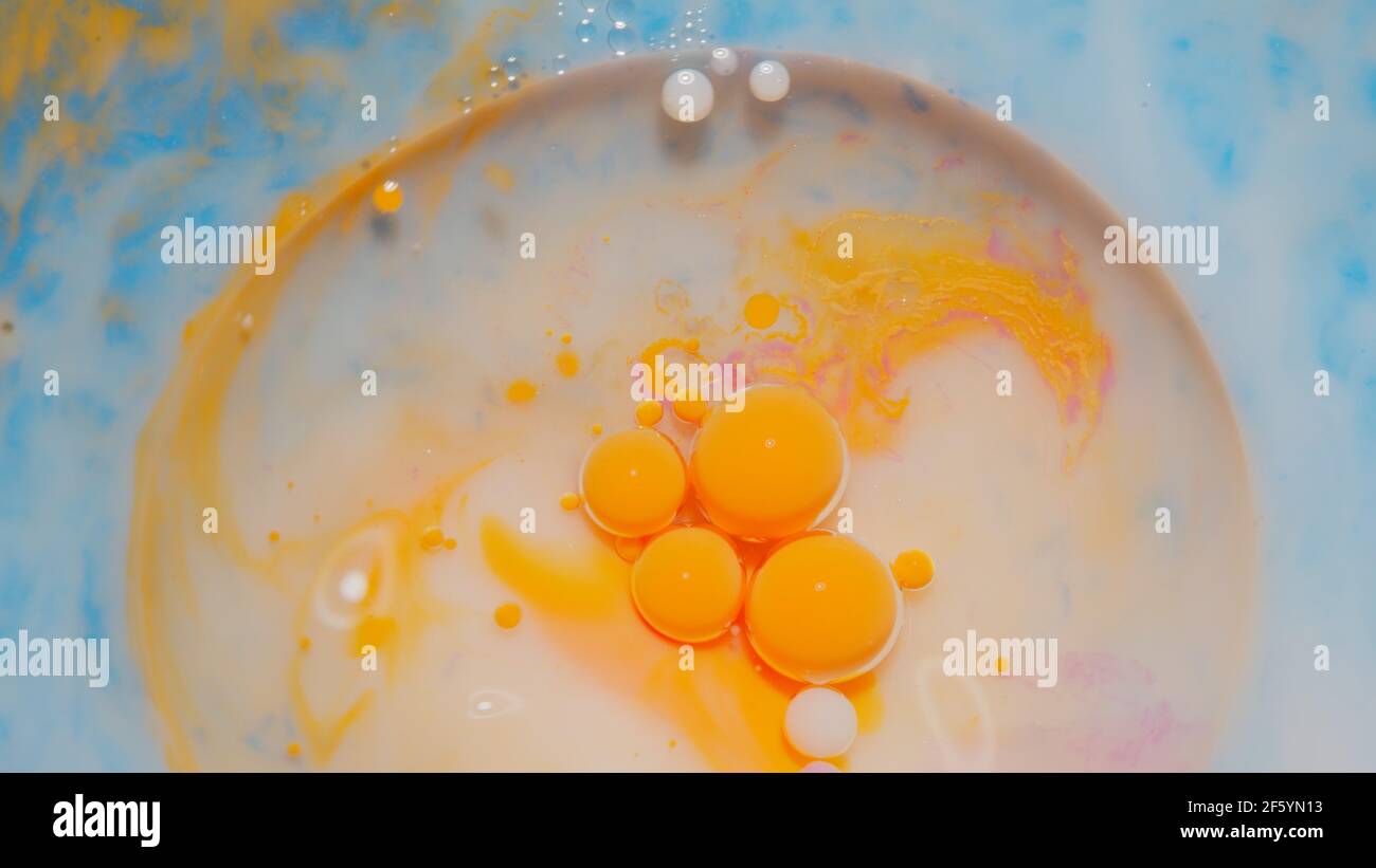 Bubbles float in liquid paint, mixing ink, oil and milk, abstract