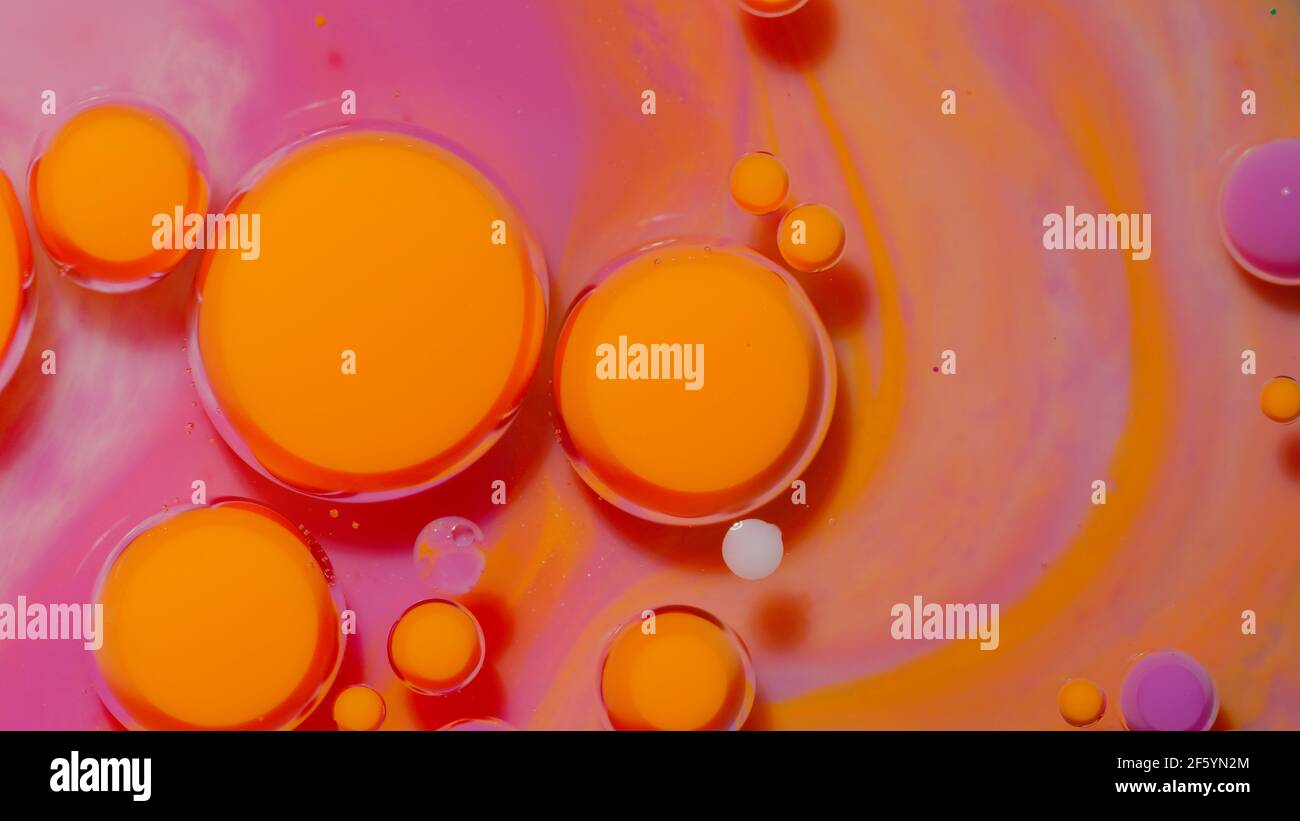 Bubbles float in liquid paint, mixing ink, oil and milk, abstract