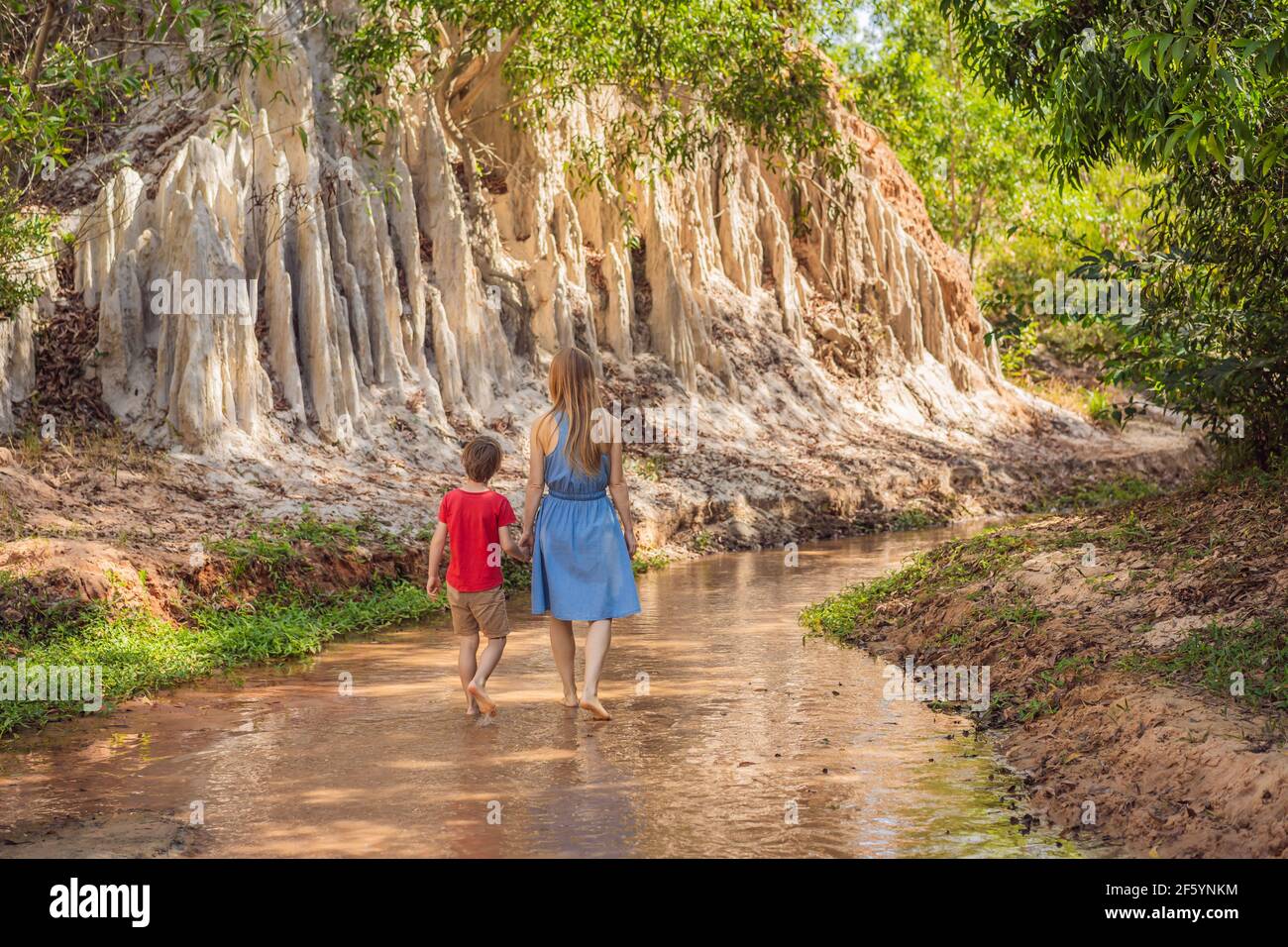 Mom and son tourists on the Fairy stream among the red dunes, Muine, Vietnam. Vietnam opens borders after quarantine COVID 19 Stock Photo