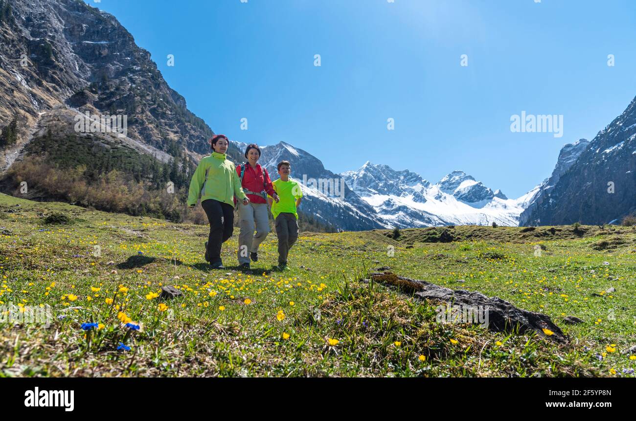 Mother with children hiking in Allgäu mountains Stock Photo