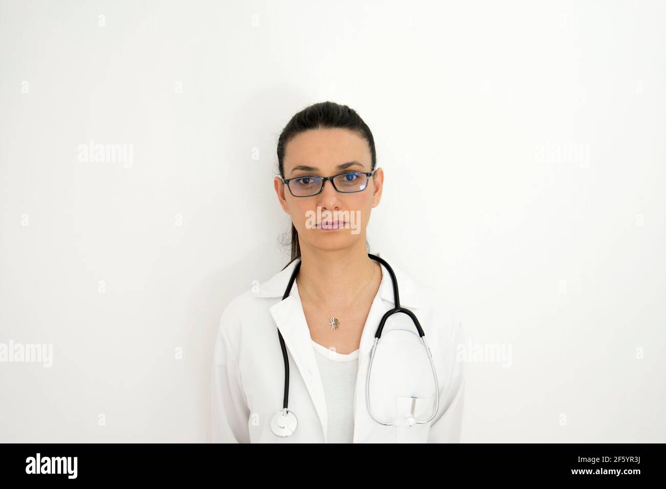 Portrait of doctor in different angle and lights in front of white wall. Selective Focus Face. Stock Photo