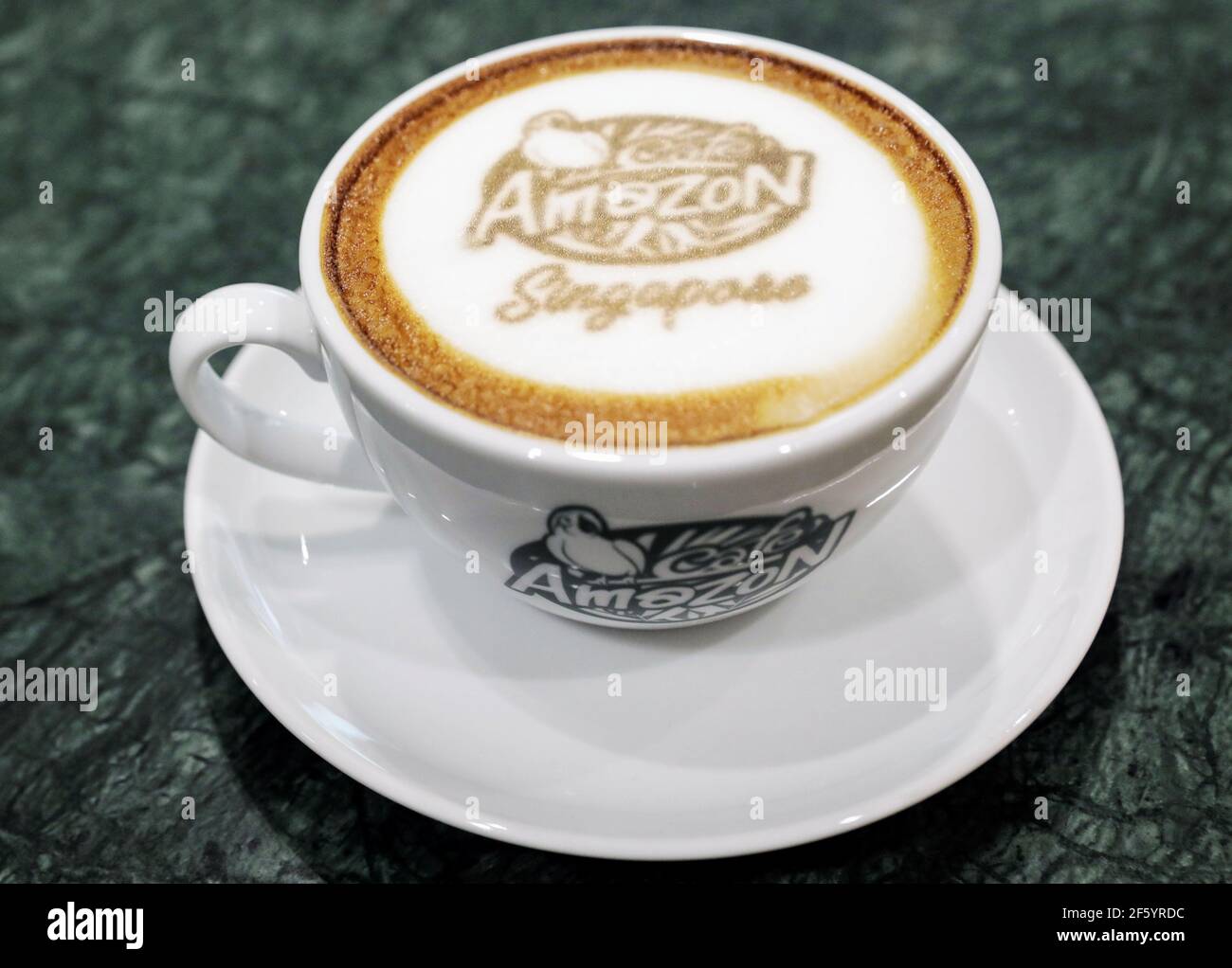A cup of Cafe Amazon coffee is pictured in Singapore's Jewel Changi Airport  March 27, 2021. Picture taken March 27, 2021. REUTERS/Dawn Chua Stock Photo  - Alamy