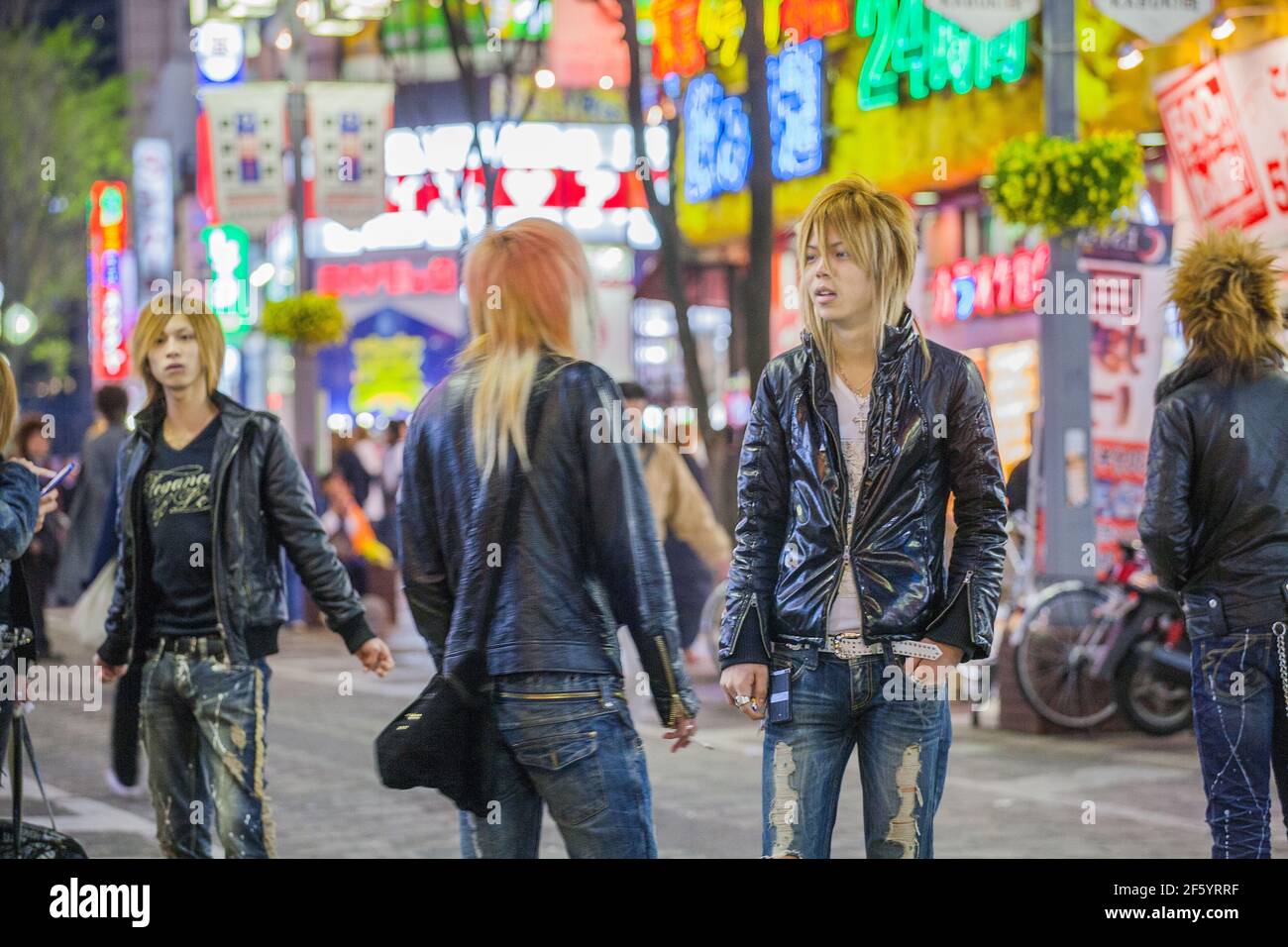 Japanese male hosts looking like rock'n'rollers touting for business on the streets of Shinjuku, Tokyo, Japan Stock Photo