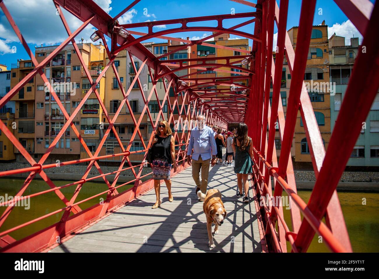 Girona, Spain - July 28, 2019: Tourists walking on the famous Eiffel Bridge in the city of Girona, Spain Stock Photo