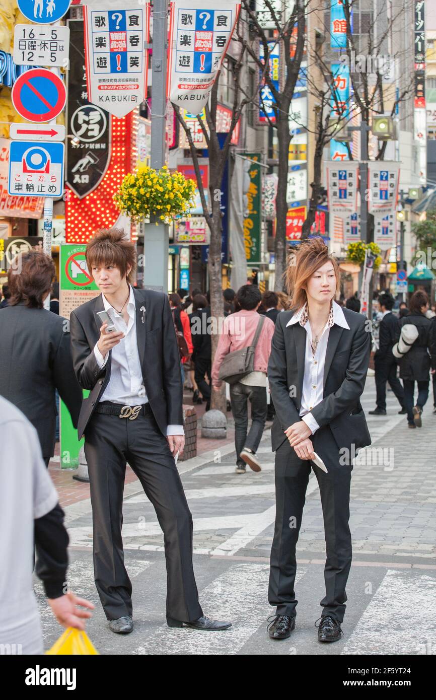 Japanese male hosts in suits touting for business on the streets of Shinjuku, Tokyo, Japan Stock