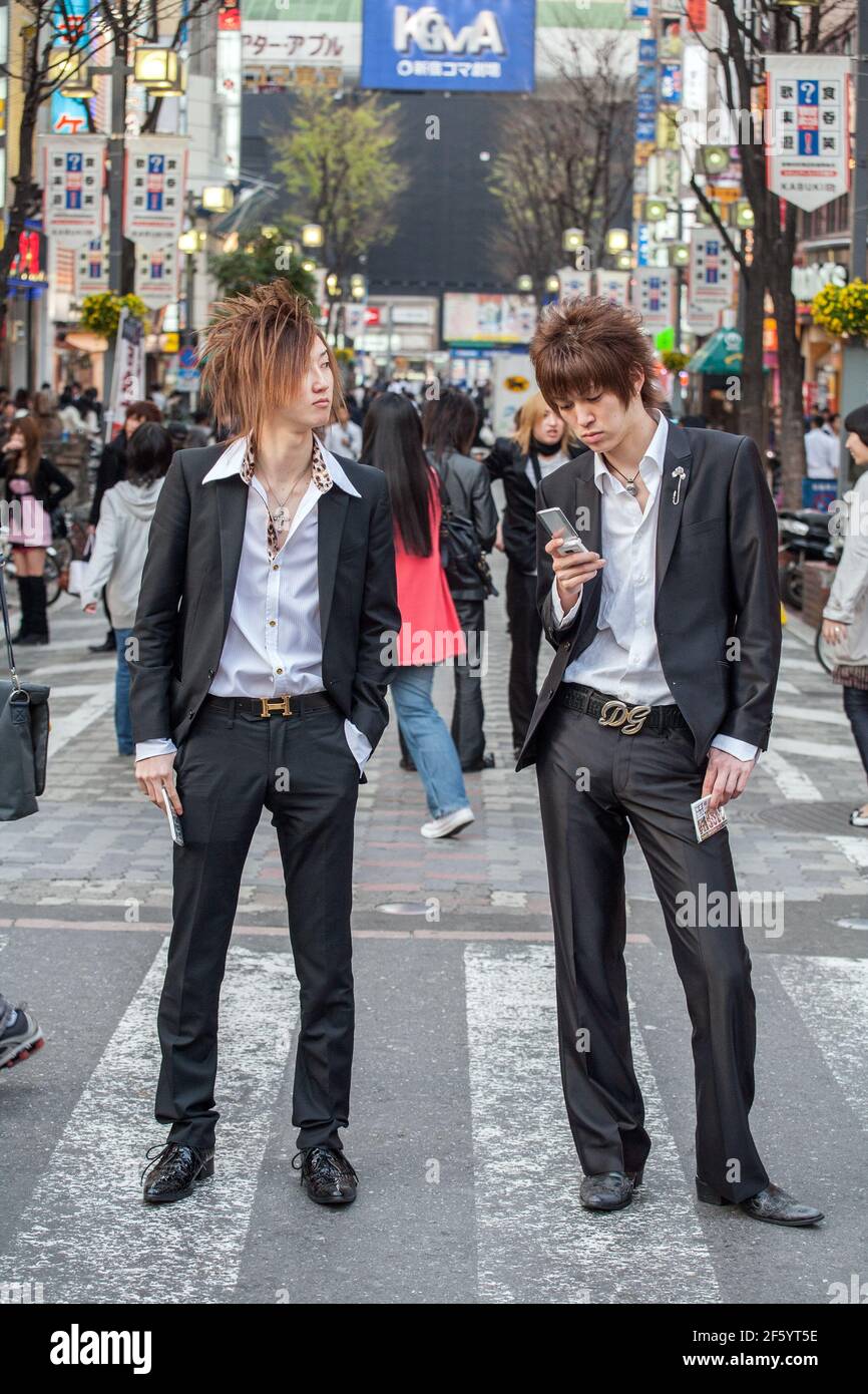 Japanese male hosts in suits touting for business on the streets of Shinjuku, Tokyo, Japan Stock Photo