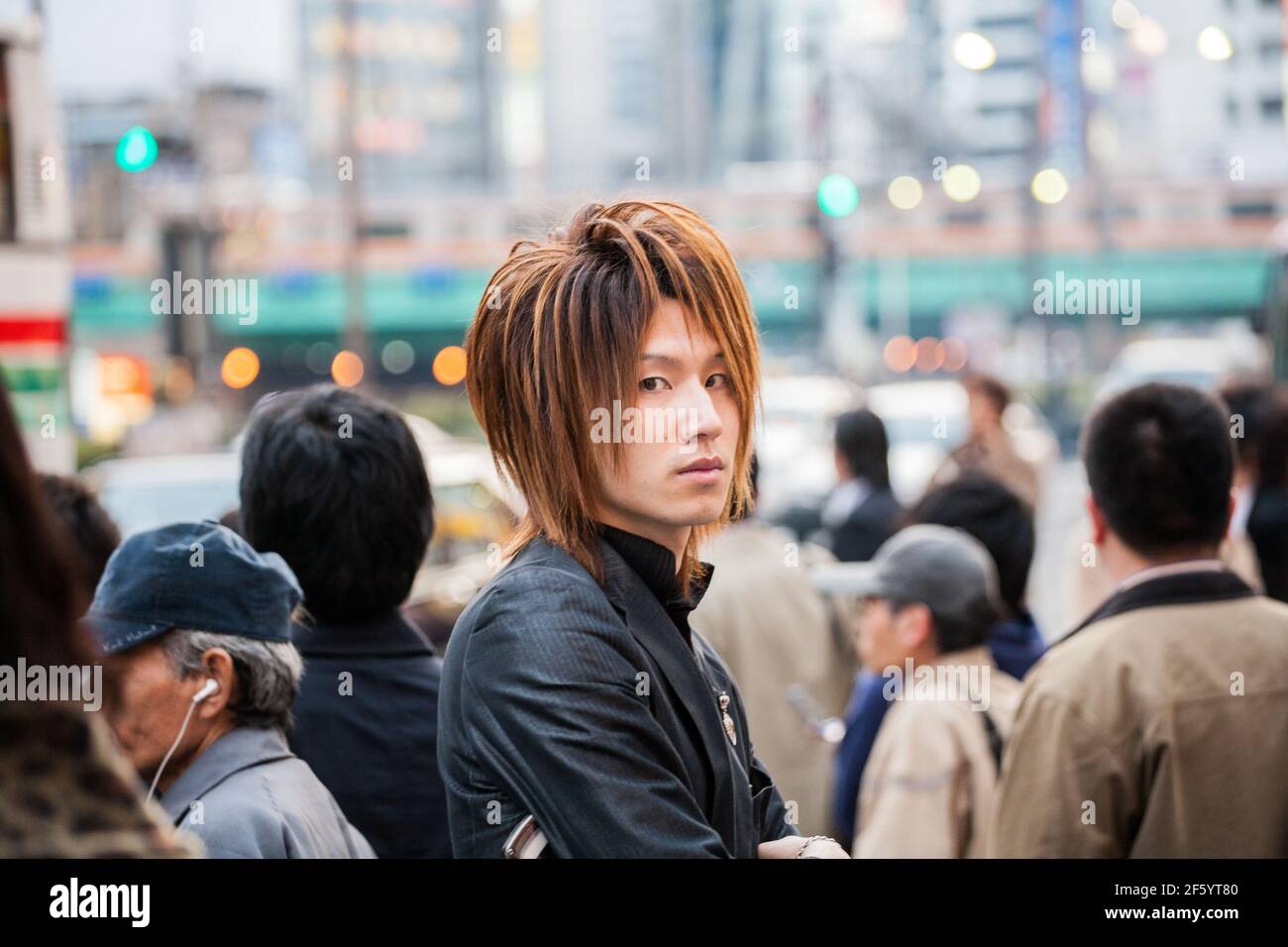Close up of Japanese male host touting for business on the streets of Shinjuku, Tokyo, Japan Stock Photo