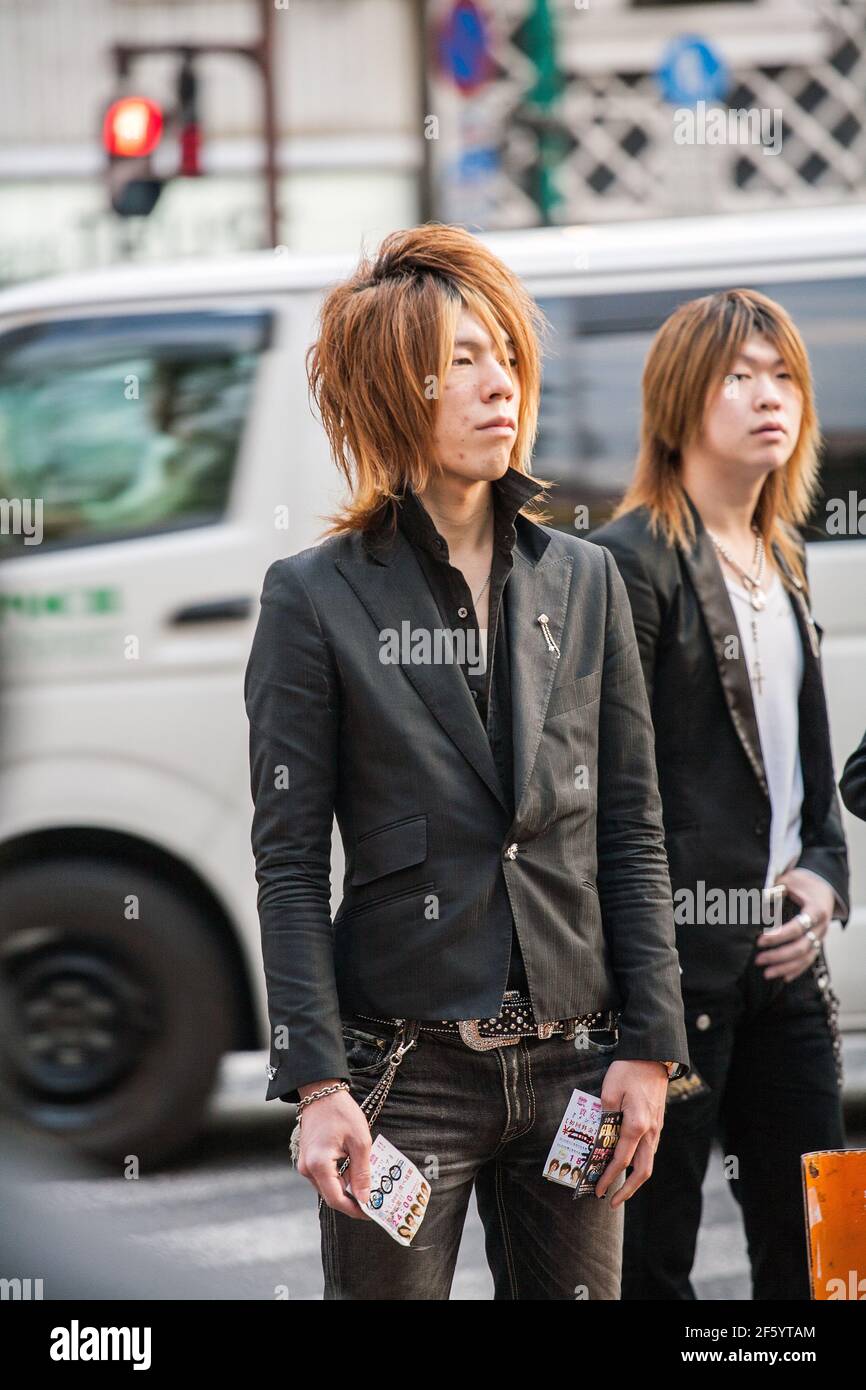 Japanese male hosts wearing suit jackets touting for business on the streets of Shinjuku, Tokyo, Japan Stock Photo