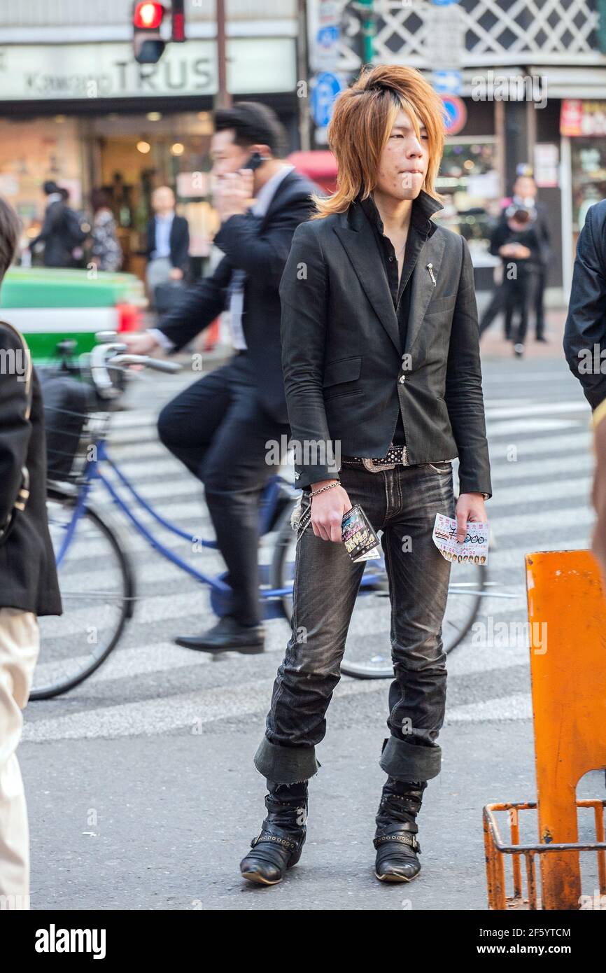 Japanese male host wearing suit jacket and jeans touting for business on the streets of Shinjuku, Tokyo, Japan Stock Photo