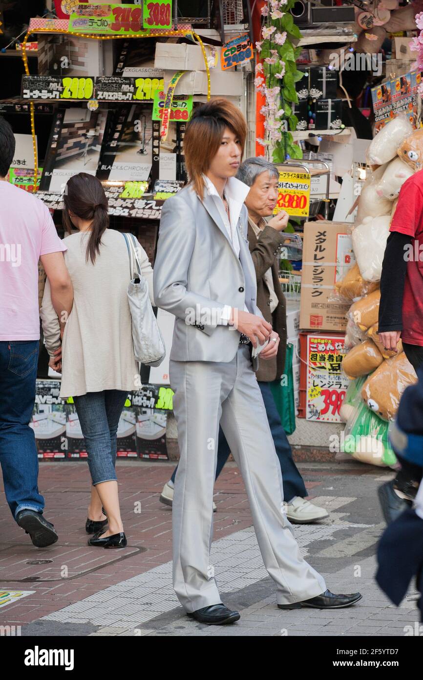 Japanese male host in suit touts for business on the streets of Shinjuku, Tokyo, Japan Stock Photo
