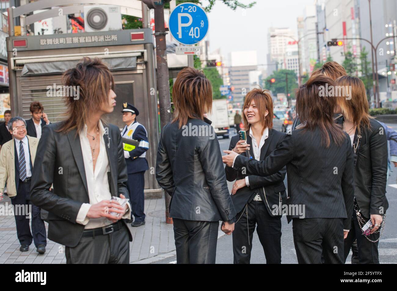 Japanese male hosts in suits touting for business on the streets of Shinjuku, Tokyo, Japan Stock Photo