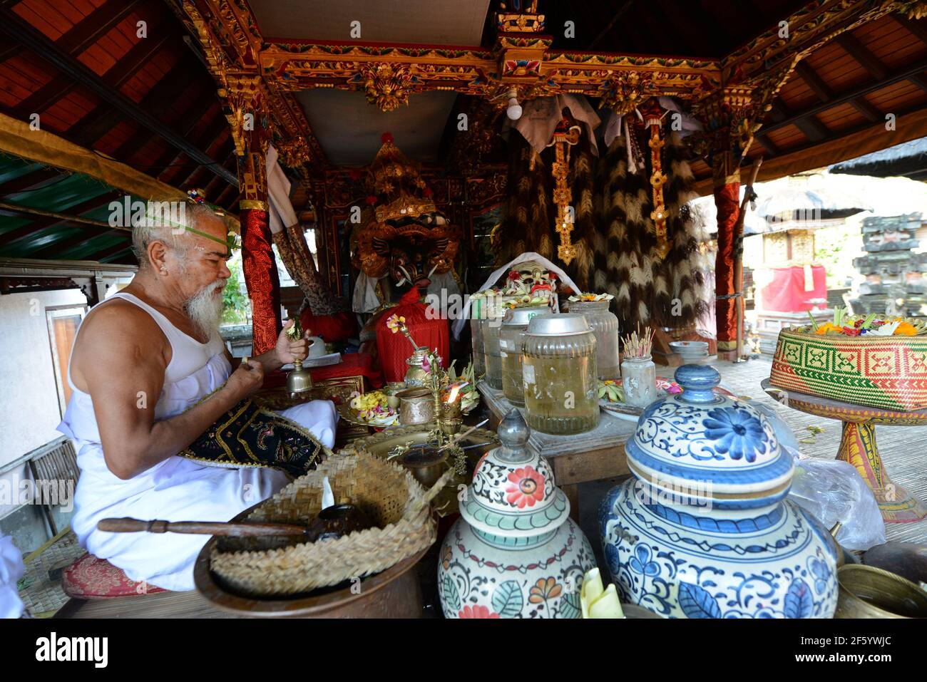 A Balinese Hindu priest blessing a groom in a pre wedding ceremony in a