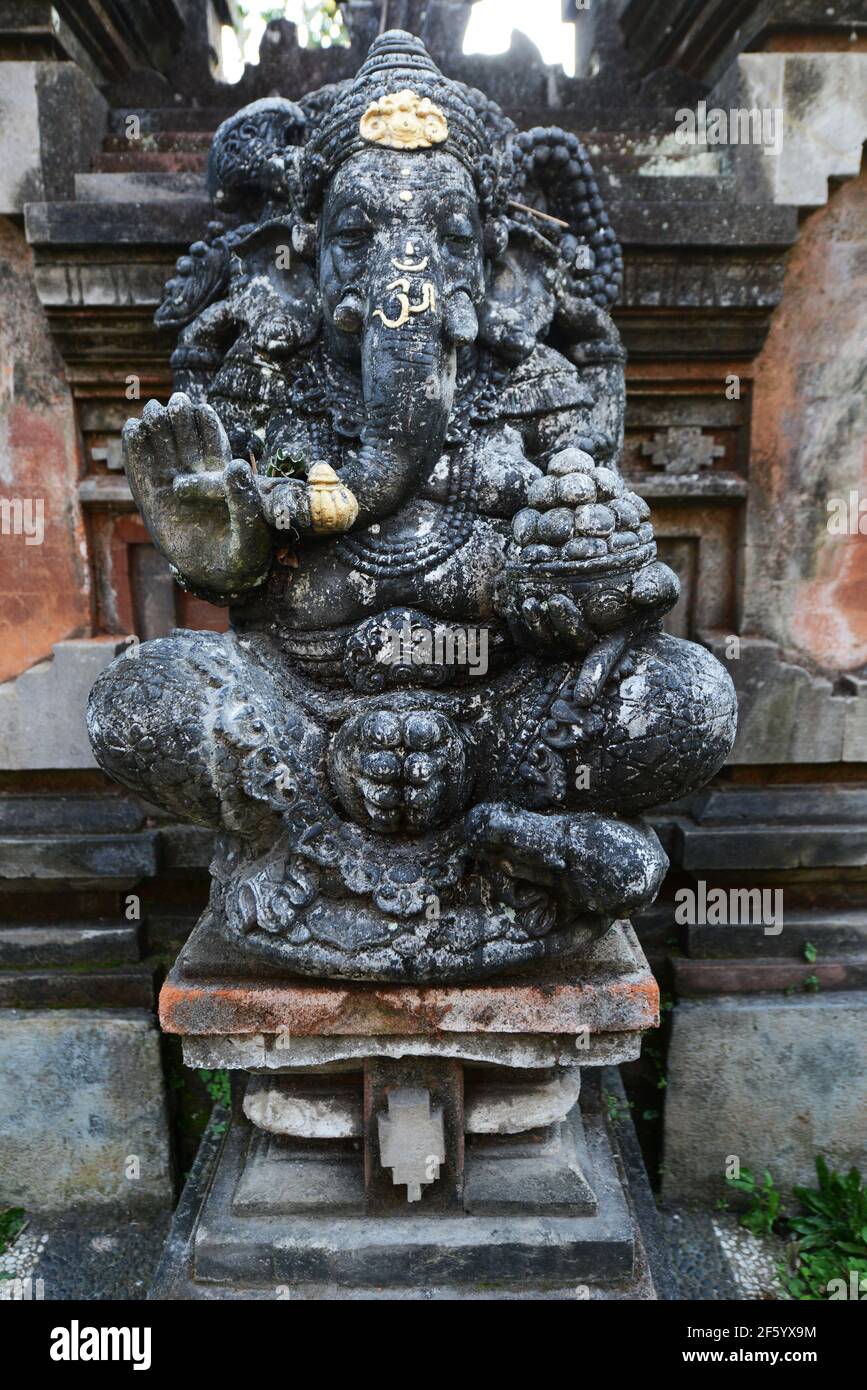 A rock carved statue of the Hindu got Ganesh in a temple in Ubud, Indonesia. Stock Photo