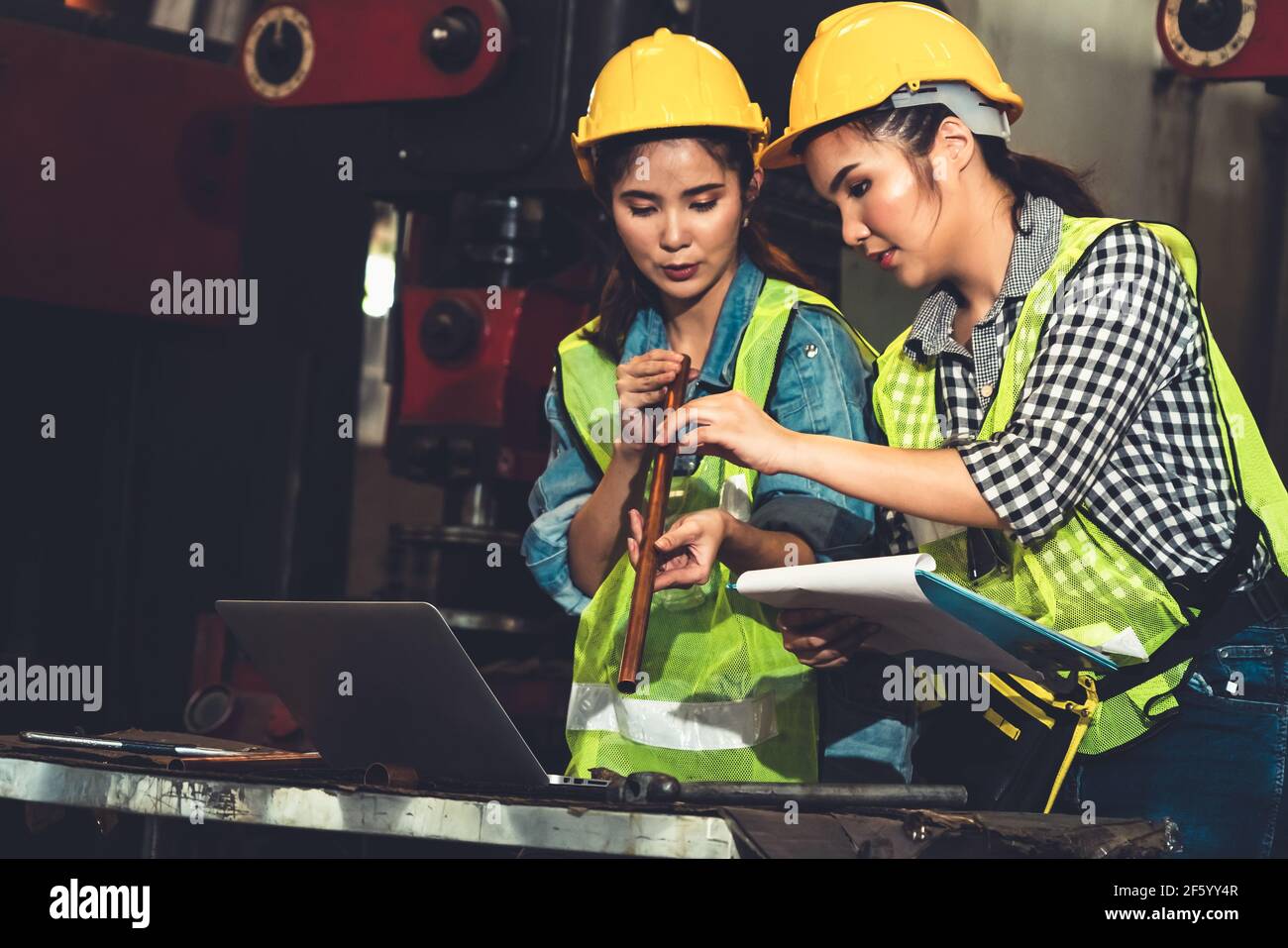 Factory job workers working and discussing manufacturing plan in the factory . Industry and engineering concept . Stock Photo