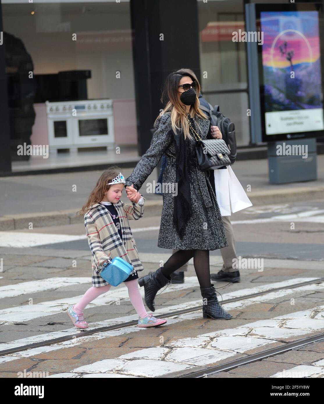 Milan, Italy. 26th Mar, 2021. Milan, Cecilia Capriotti and daughter Maria  Isabelle in the center for shopping Cecilia Capriotti surprised walking  through the streets of the center with her daughter Maria Isabelle,