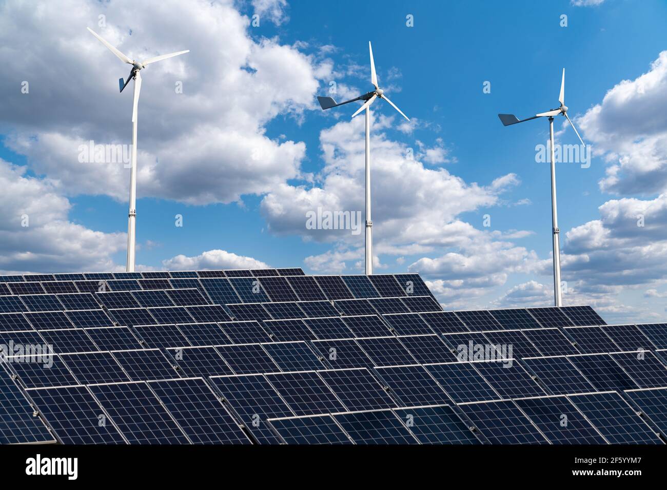 Solar panels and wind turbines on a green field. Sustainable energy ...